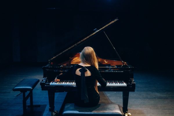 The back of a woman playing piano